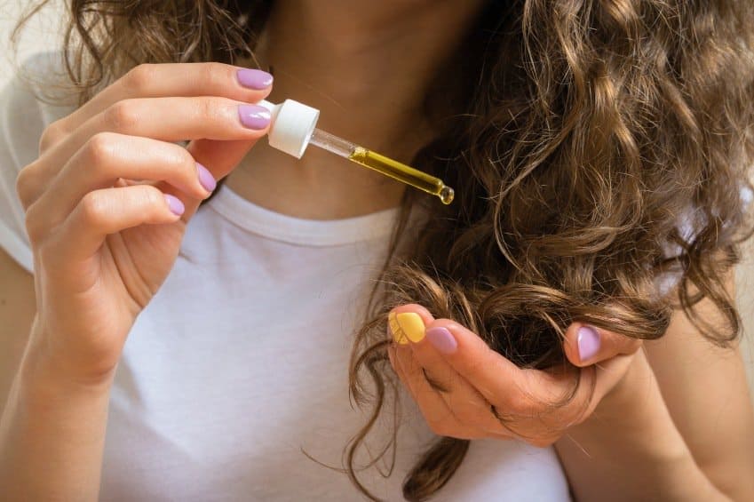 woman using coconut oil for hair