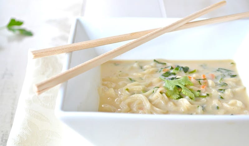 a bowl of ramen noodles with chopsticks