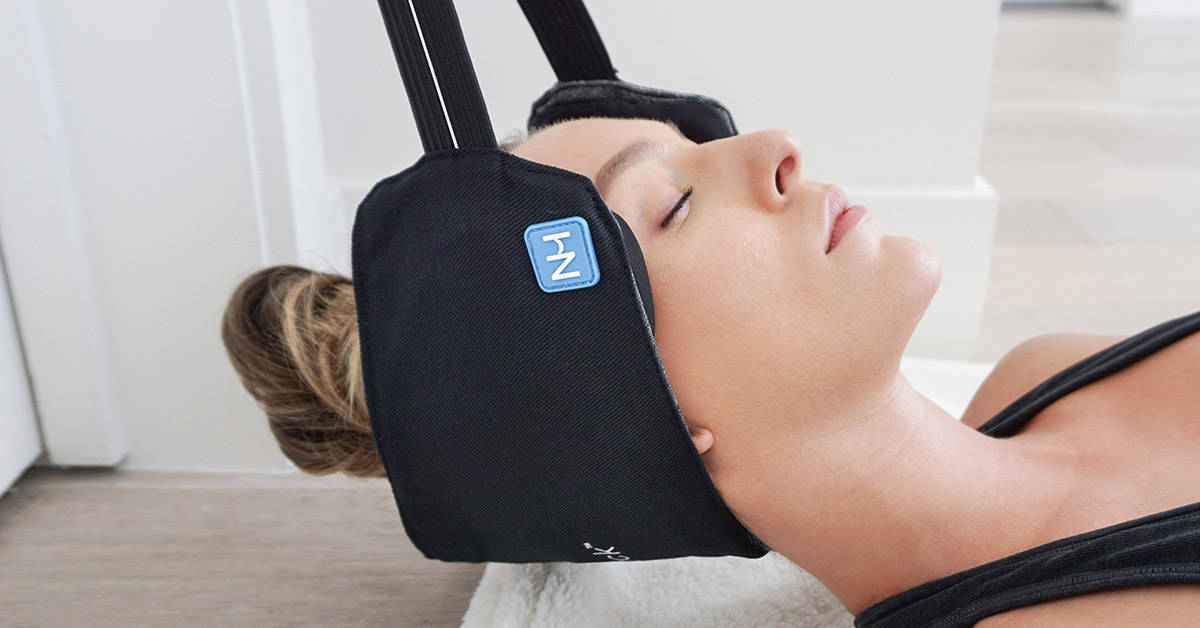 woman relieving neck pain with neck hammock