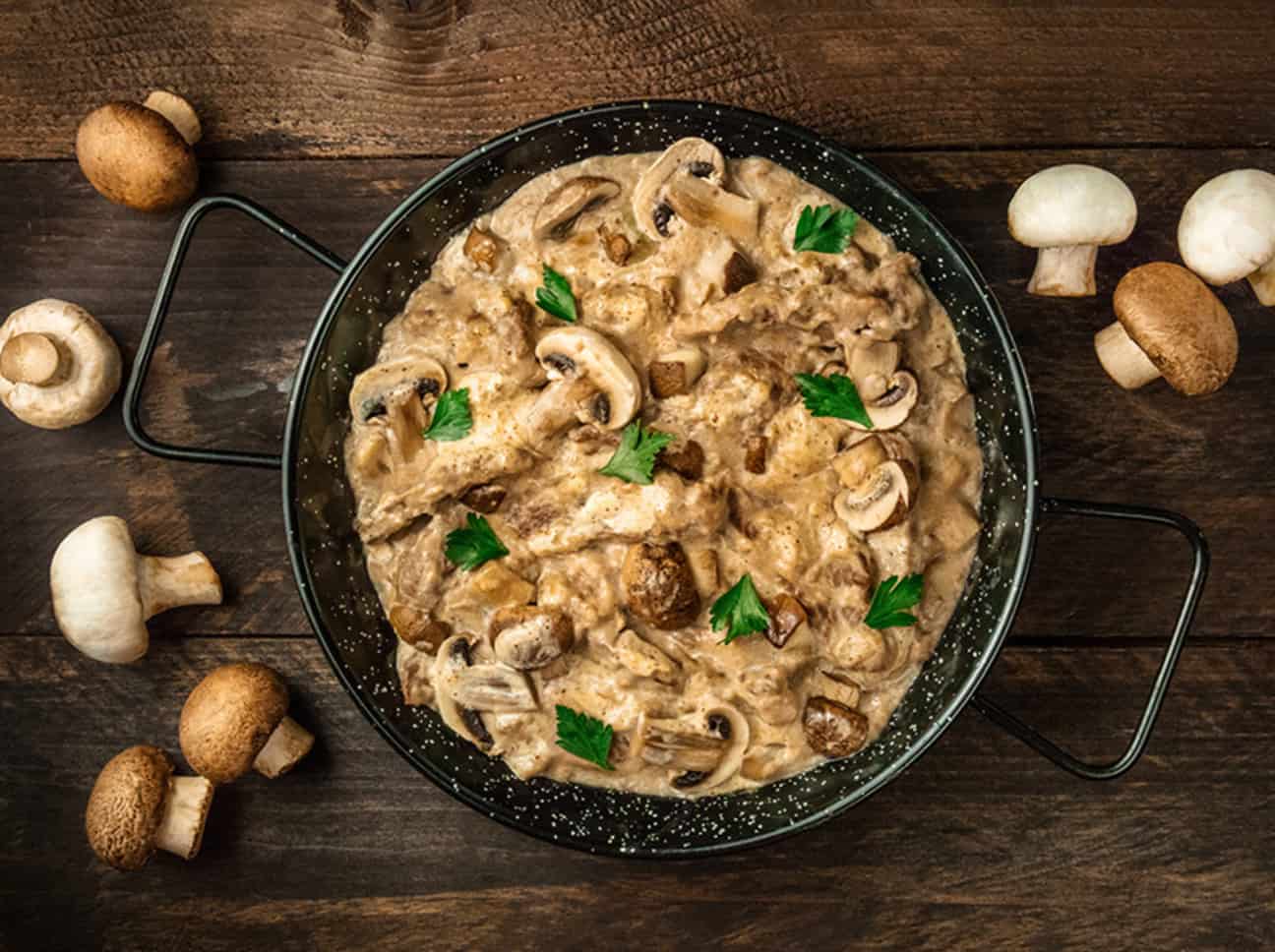 a pot of beef stroganoff with mushrooms and sour cream